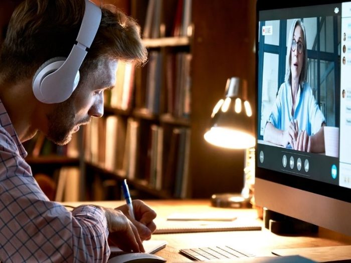Man taking notes during a video call
